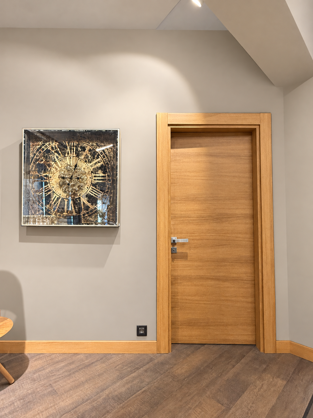 Interior door with a natural wood finish and warm greige walls